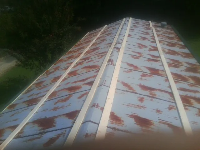 Rusted metal roof panels with new wood purlins before replacement — Storm Damage Roof Repair in Vaughan by Roofing Brothers